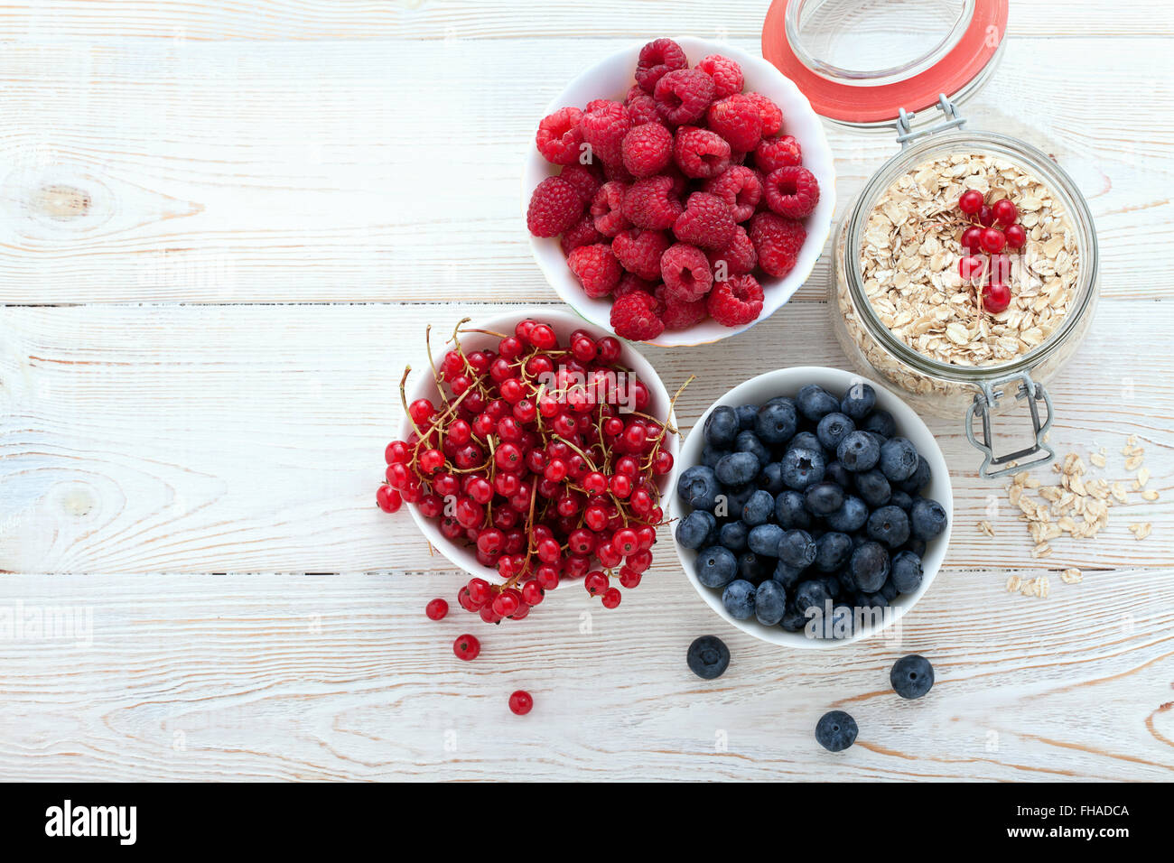 Breakfast berries, fruit and muesli on white wooden Stock Photo Alamy