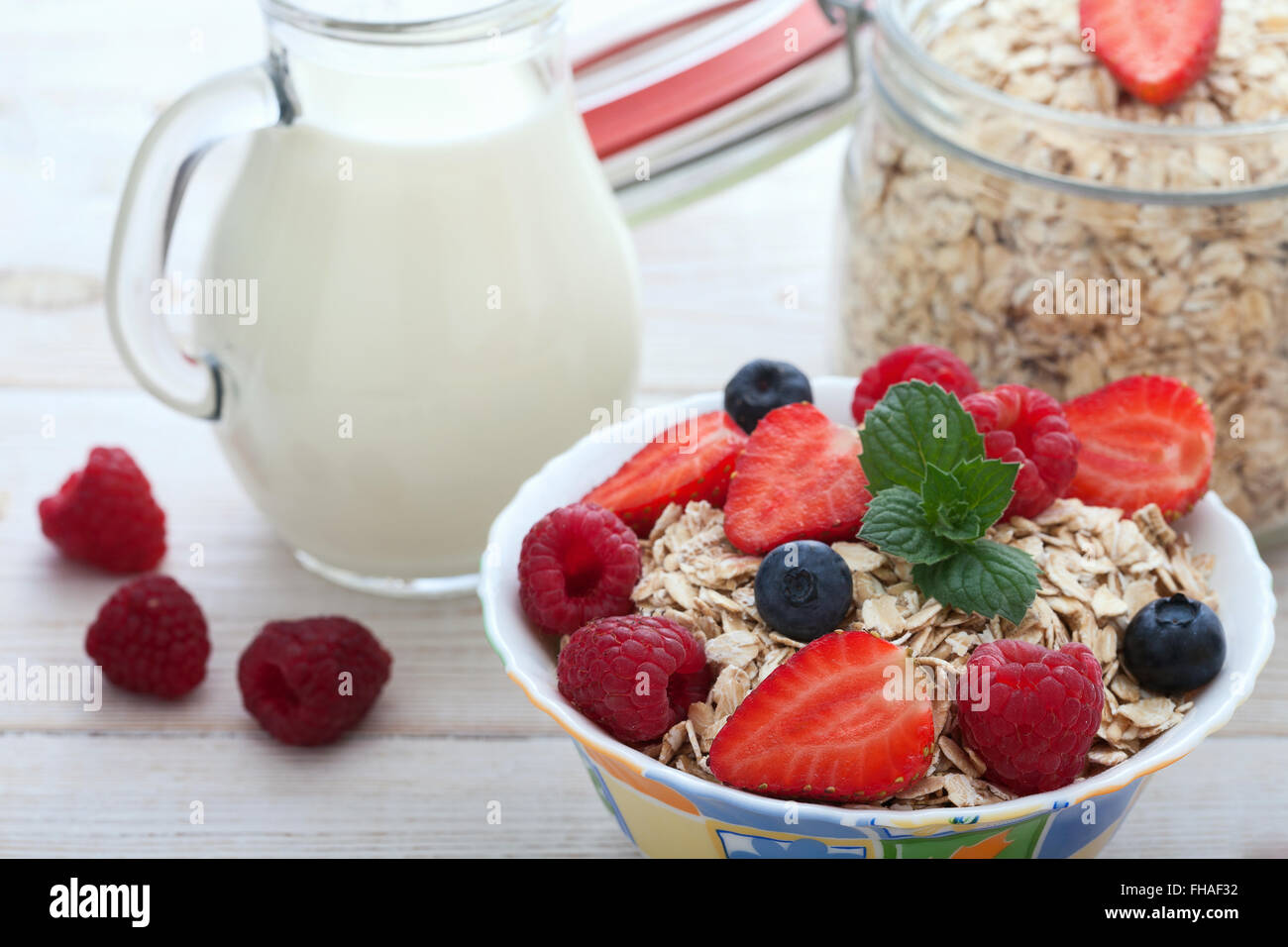 Breakfast berries, fruit and muesli on white wooden Stock Photo Alamy