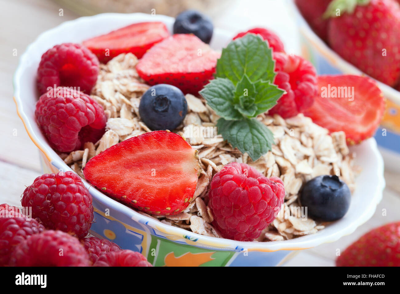 Breakfast berries, fruit and muesli on white wooden Stock Photo Alamy