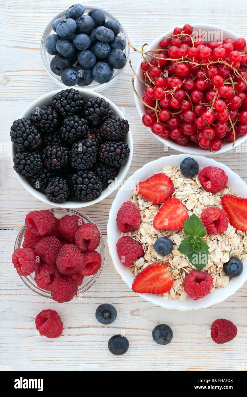 Breakfast berries, fruit and muesli on white wooden Stock Photo Alamy