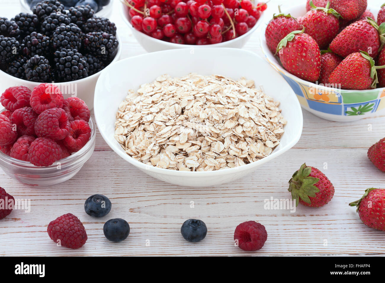 Breakfast berries, fruit and muesli on white wooden Stock Photo Alamy