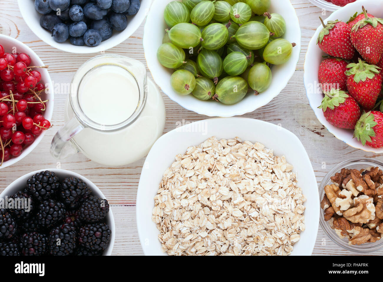Breakfast berries, fruit and muesli on white wooden Stock Photo Alamy