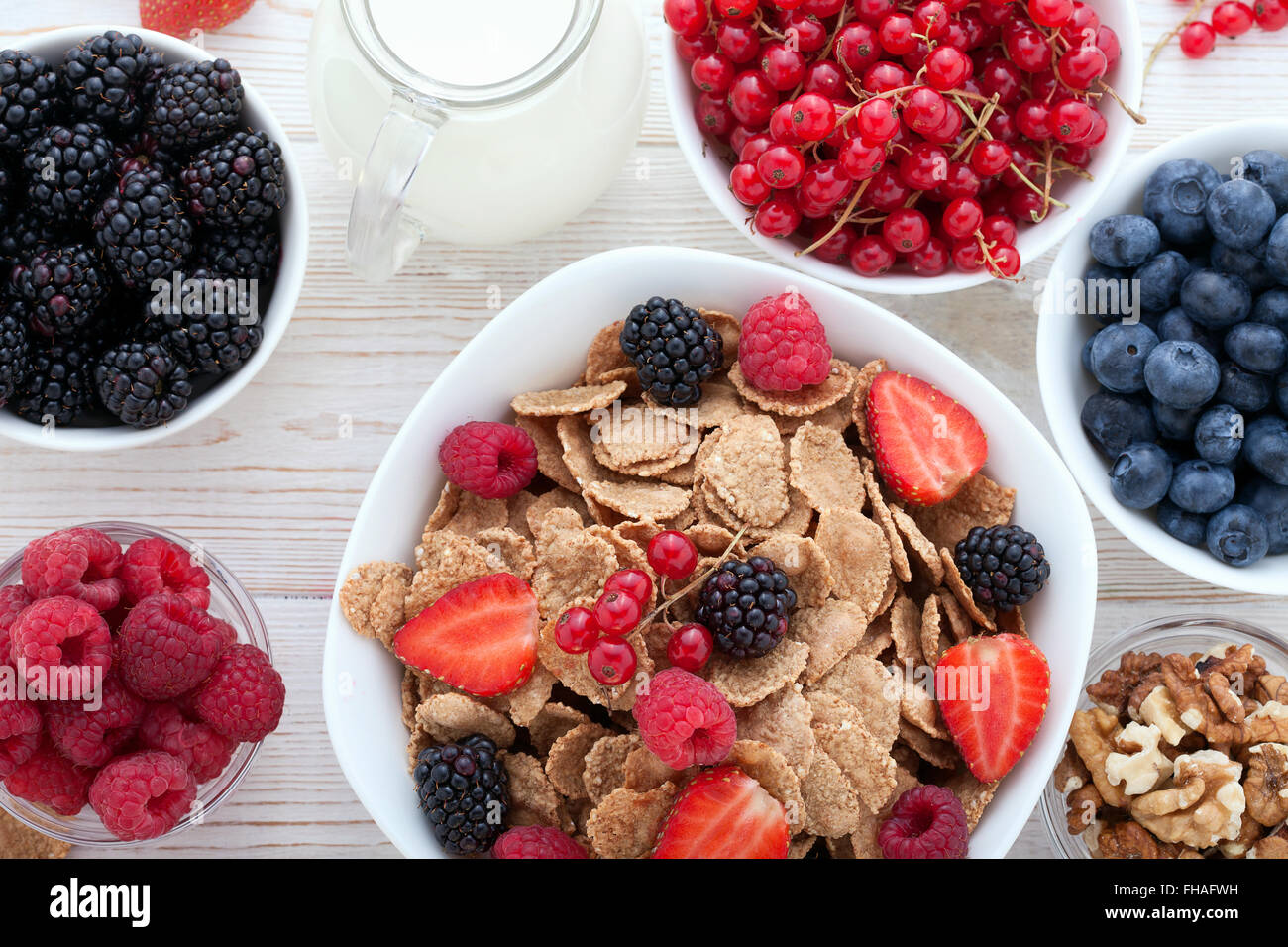 Breakfast berries, fruit and muesli on white wooden Stock Photo Alamy