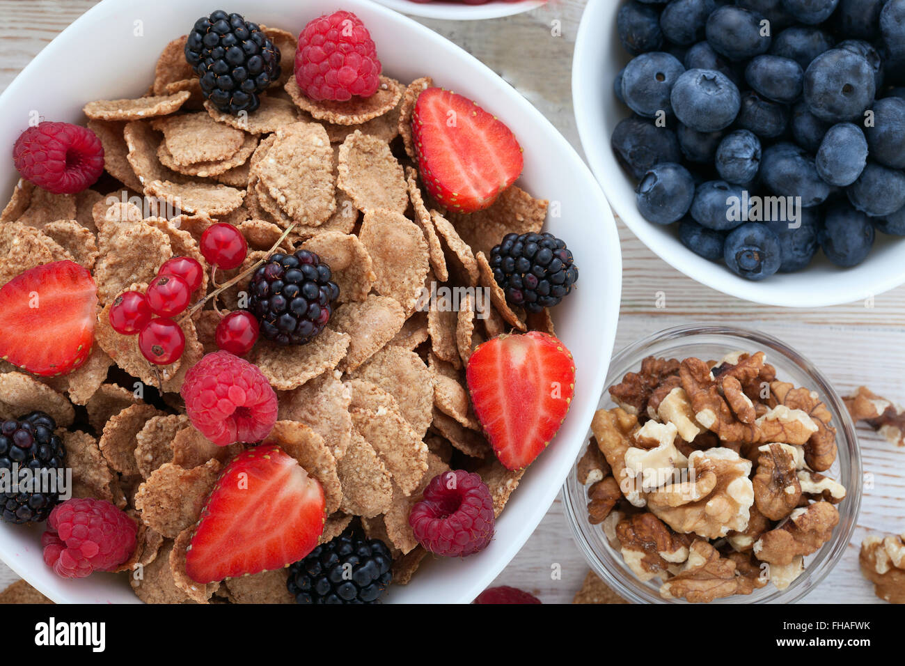 Breakfast berries, fruit and muesli on white wooden Stock Photo Alamy