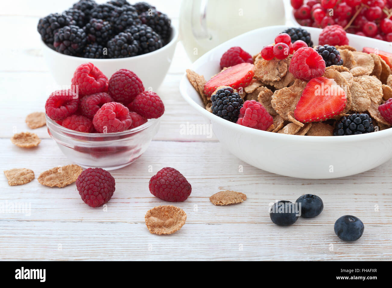 Breakfast berries, fruit and muesli on white wooden Stock Photo Alamy