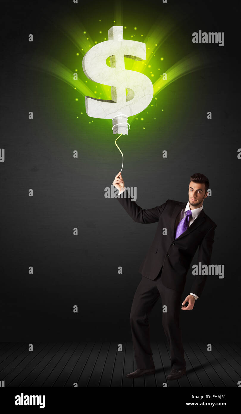 Businessman with a dollar sign balloon Stock Photo - Alamy
