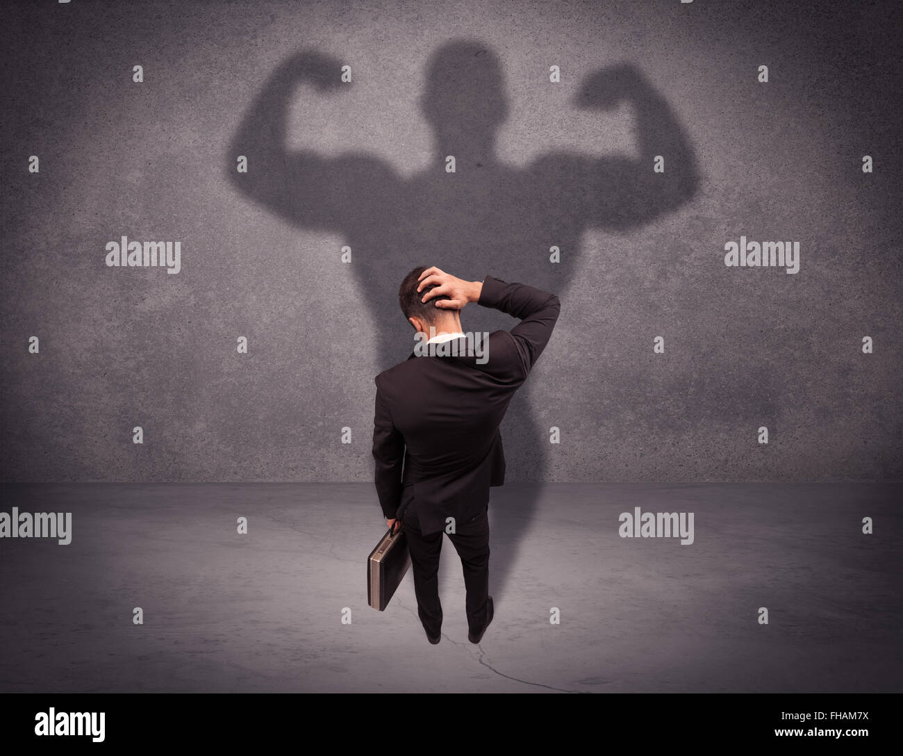 Successful businessman with strong shadow Stock Photo - Alamy