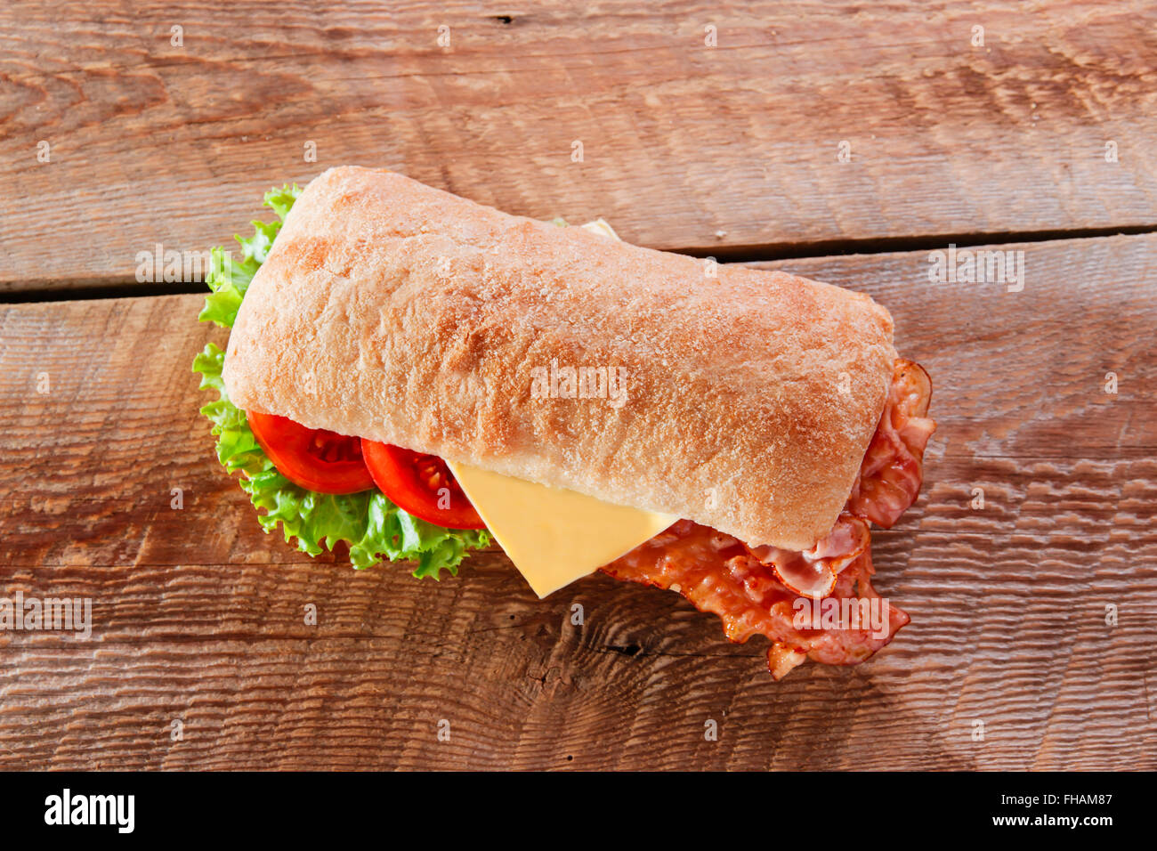 sandwich with fried bacon cheese tomato ciabatta Stock Photo Alamy