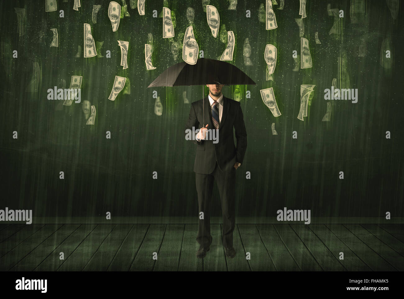 Businessman standing with umbrella in dollar bill rain concept Stock ...