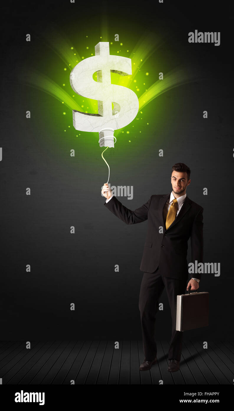 Businessman with a dollar sign balloon Stock Photo - Alamy