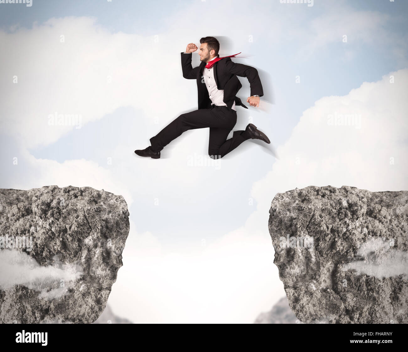 Funny business man jumping over rocks with gap Stock Photo - Alamy