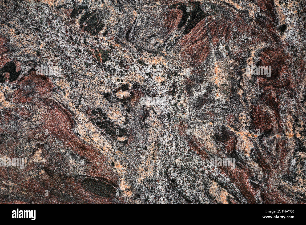 Pattern of a dark marbled, smooth polished stone slab in red brown and black with gray and pale orange Stock Photo