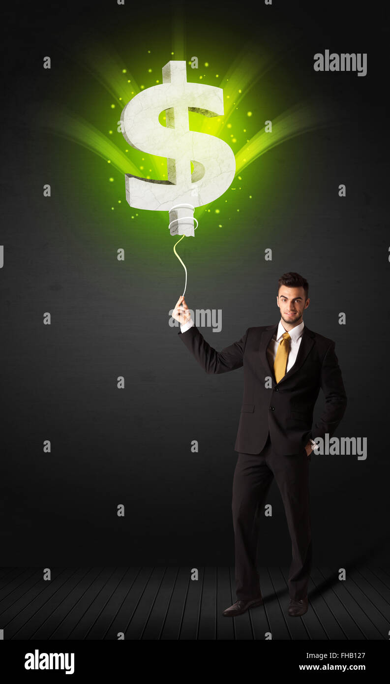 Businessman with a dollar sign balloon Stock Photo - Alamy