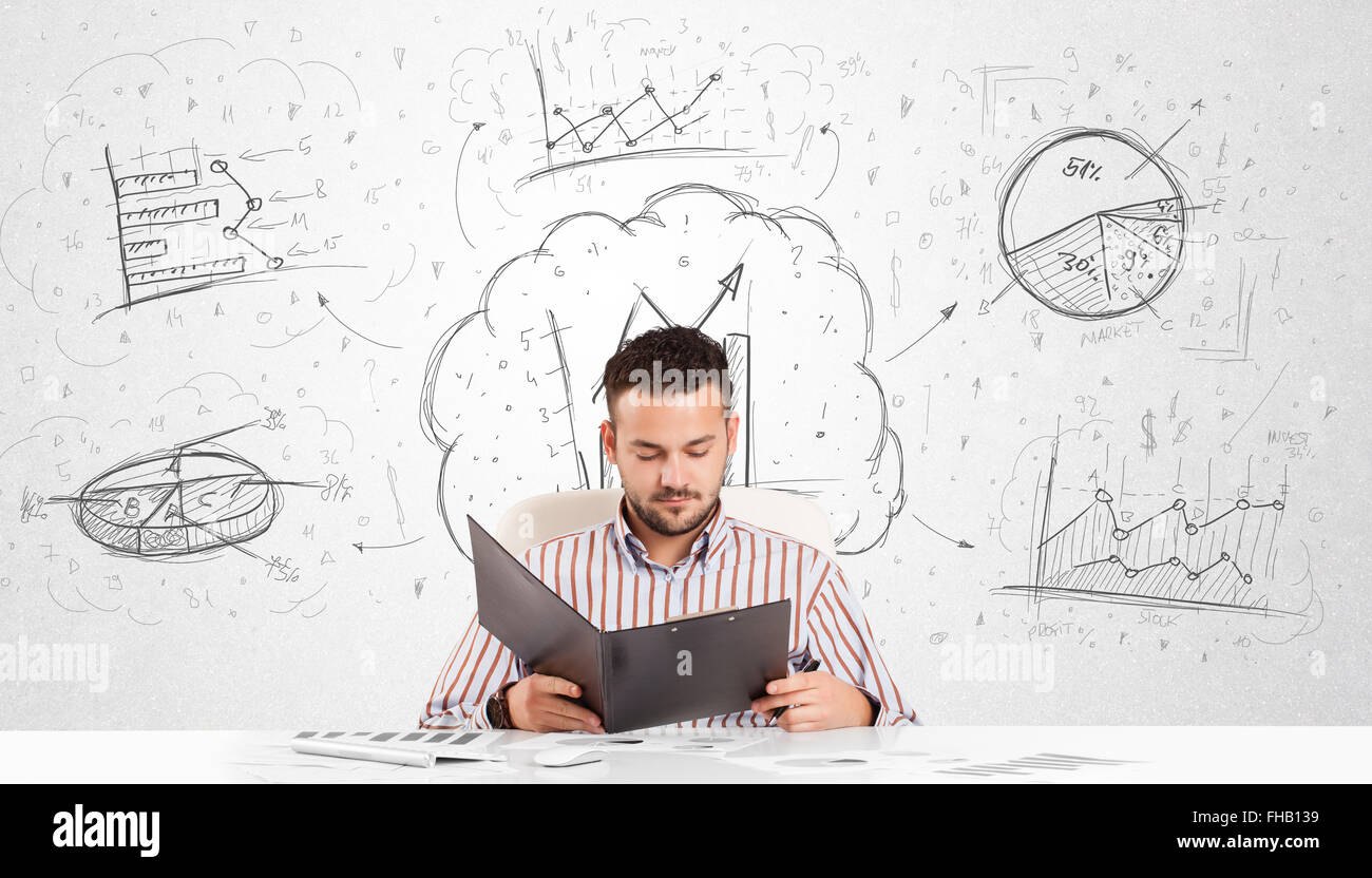 Business man sitting at table with hand drawn graph charts Stock Photo