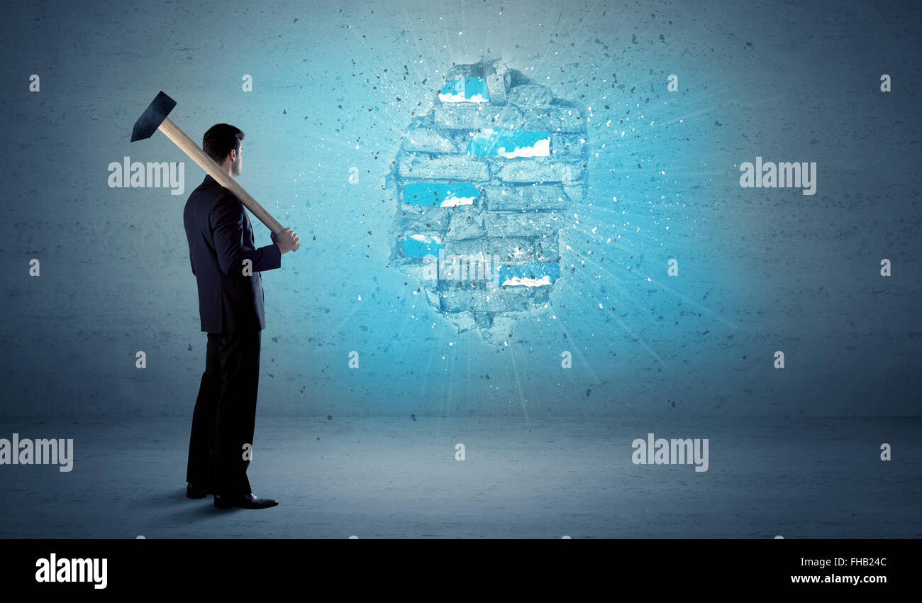 Business man hitting brick wall with huge hammer Stock Photo Alamy