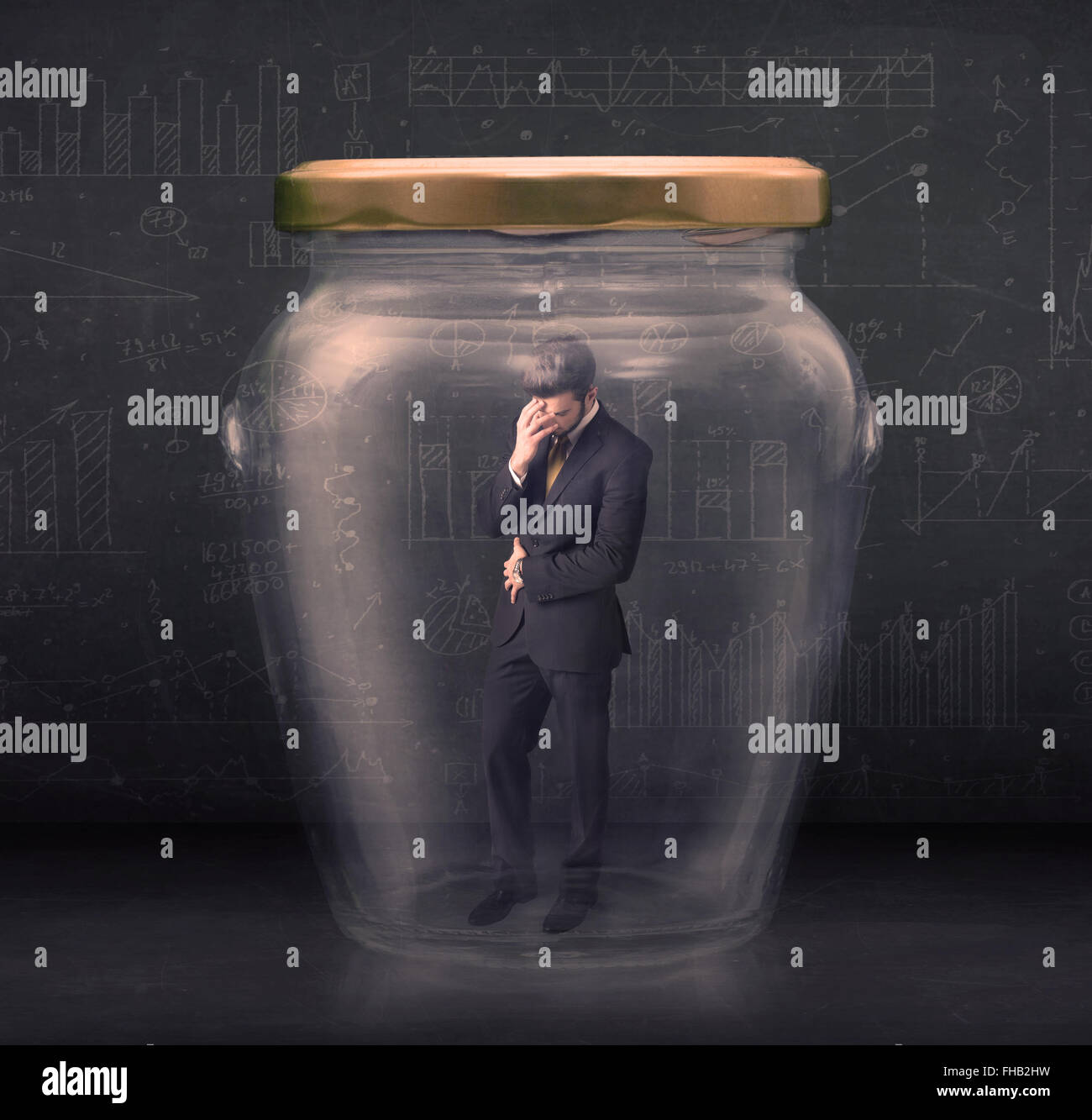 Business man closed into a glass jar concept Stock Photo