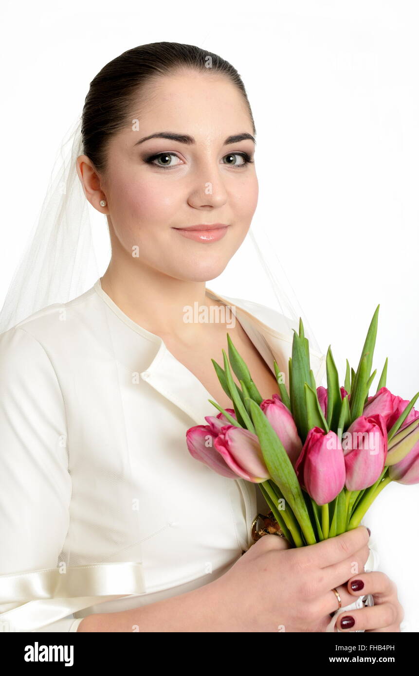 Happy bride with white veil and tulips bouquet in her hand. Young ...