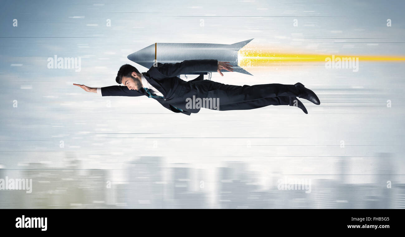 Superhero business man flying with jet pack rocket above the city Stock ...