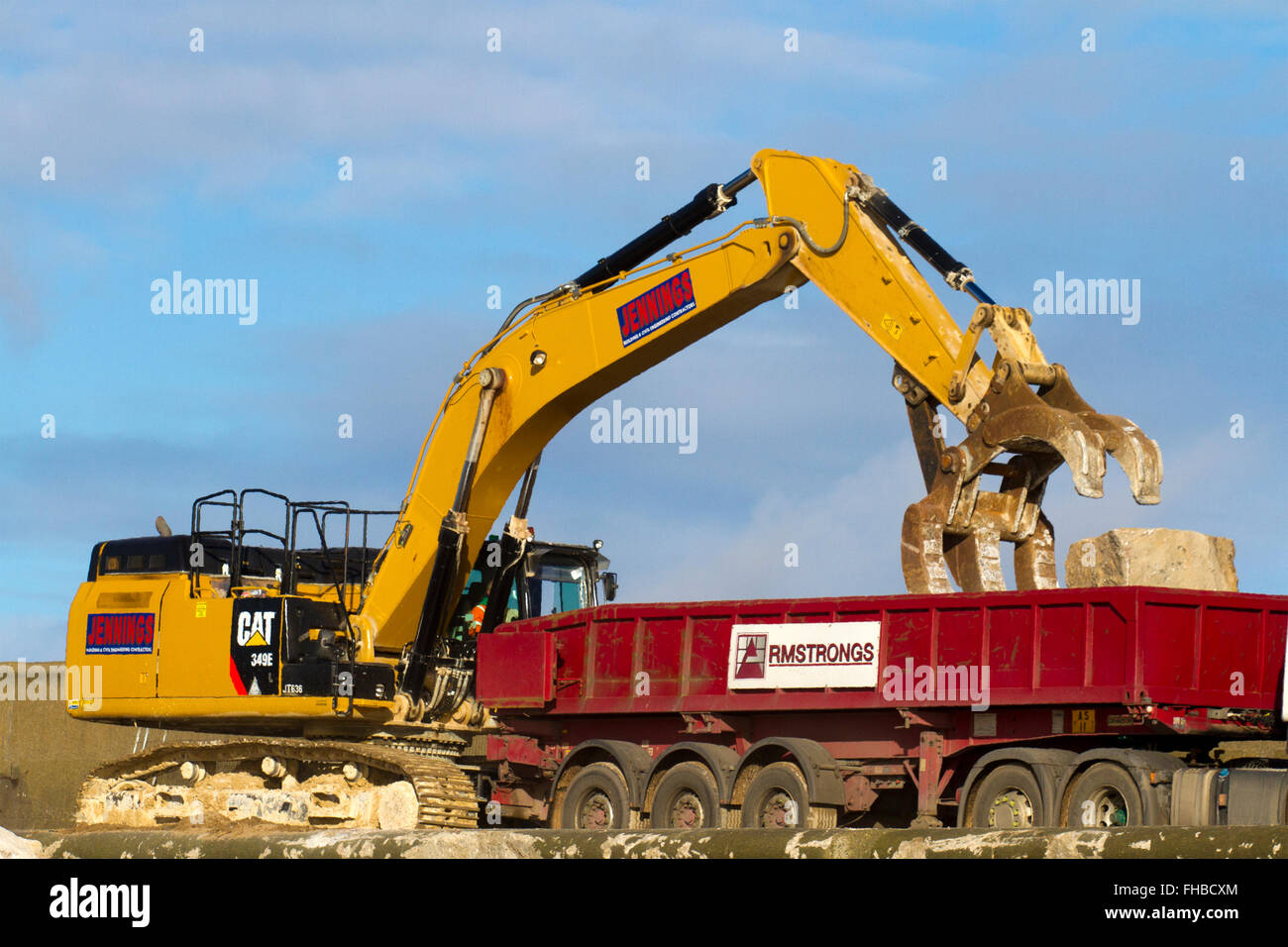 Blackpool, Fleetwood, Lancashire, UK. 24th February, 2016. Rossall Coastal defence £86million project resumes.  After recent storms and high winds, rock placement continues on the revetment at the southern end of the works with an additional 9,500 tonnes of primary rock placed. Primary rock placement now totals 95,000 tonnes and 171,500 tonnes of it have now been delivered to site.  Cernan Elias/Alamy Live News Stock Photo