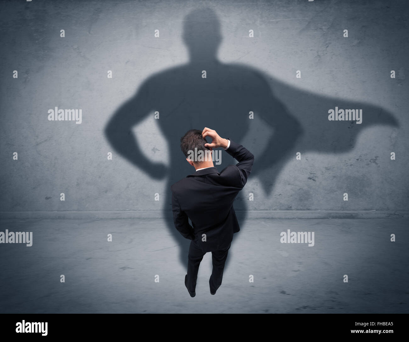 Successful businessman with superhero shadow Stock Photo - Alamy