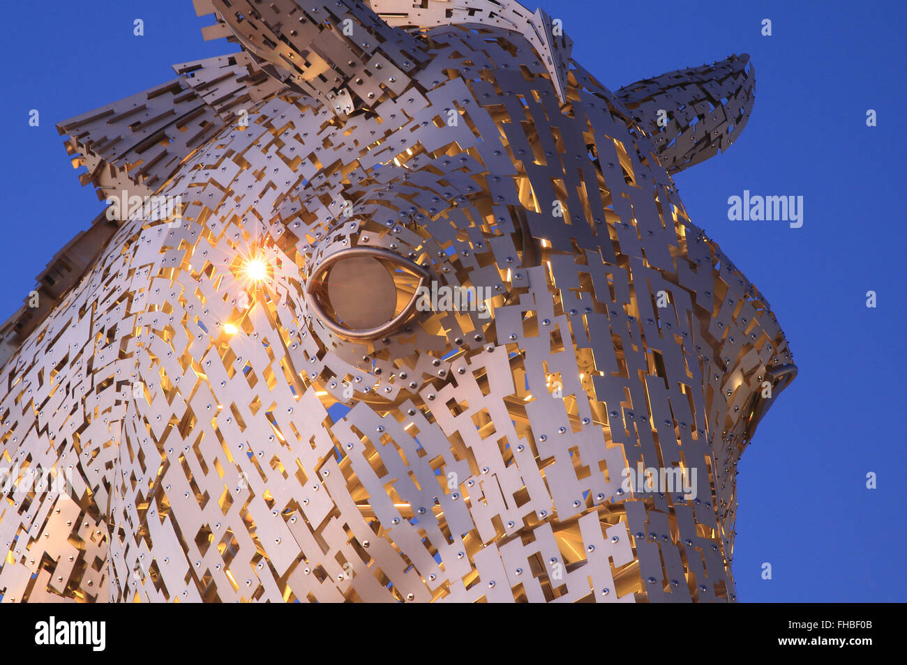 Detail of the eye of one of the Kelpies, illuminated at dusk, the world's largest horse sculptures, in Falkirk, Scotland, UK Stock Photo