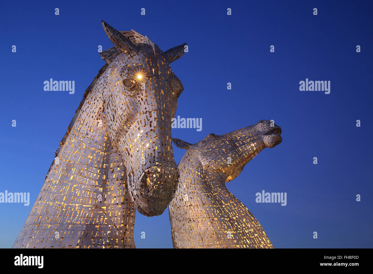 The Kelpies, the world's largest horse sculptures, illuminated at dusk