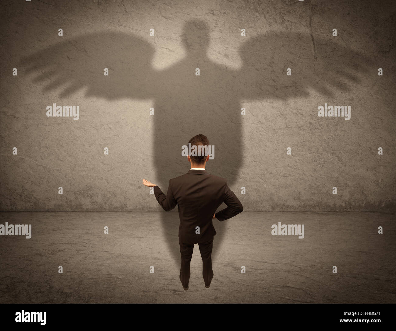 Honest salesman with angel shadow concept Stock Photo - Alamy