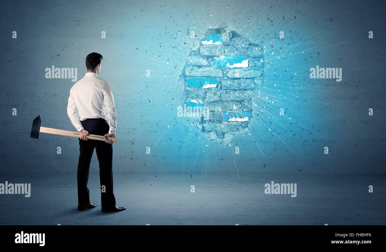 Business man hitting brick wall with huge hammer Stock Photo Alamy