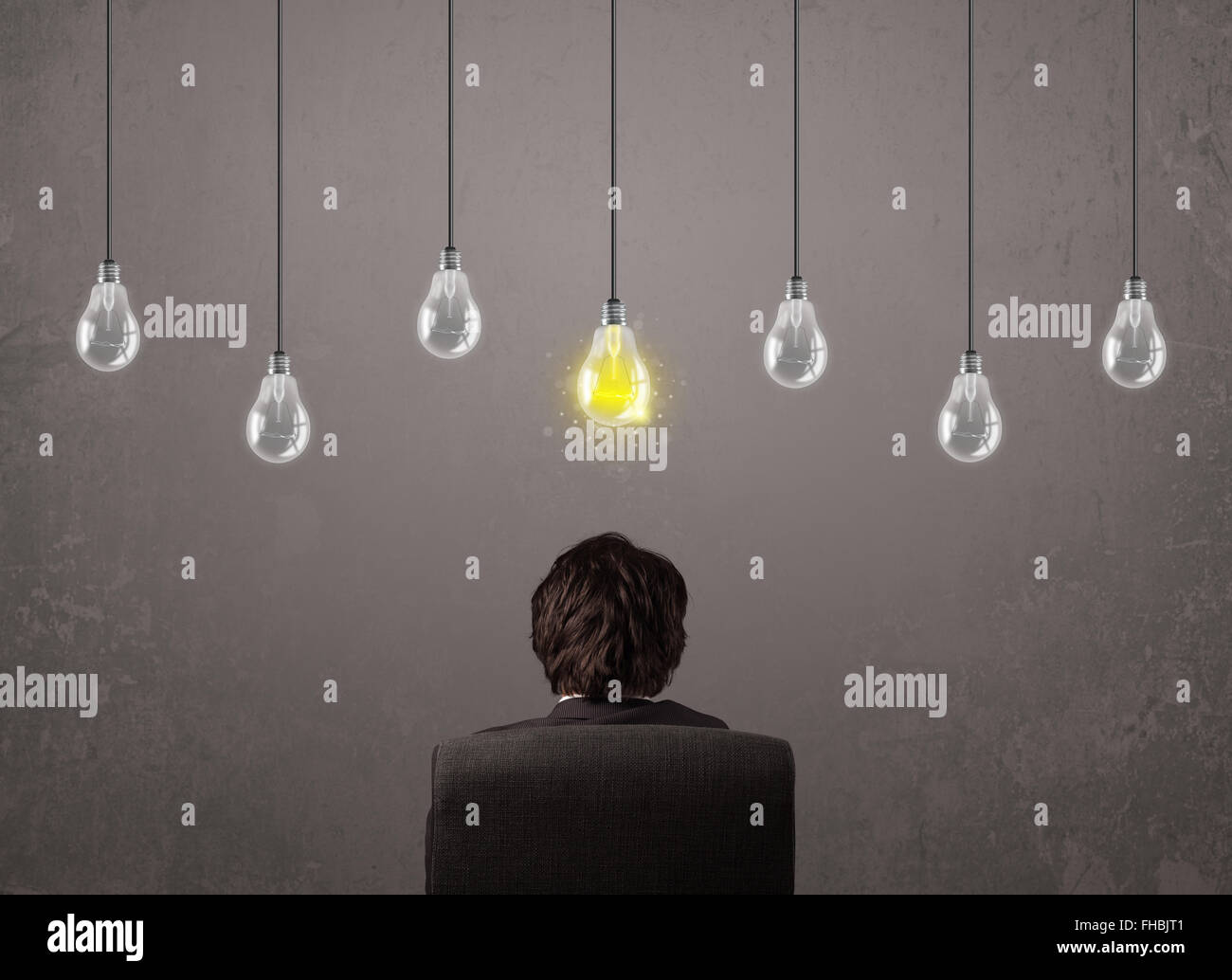 Businness guy in front of idea light bulbs concept Stock Photo - Alamy