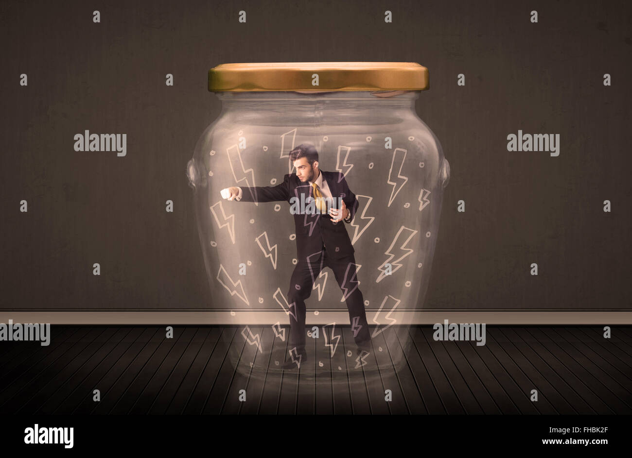 Businessman inside a glass jar with lightning drawings concept Stock Photo