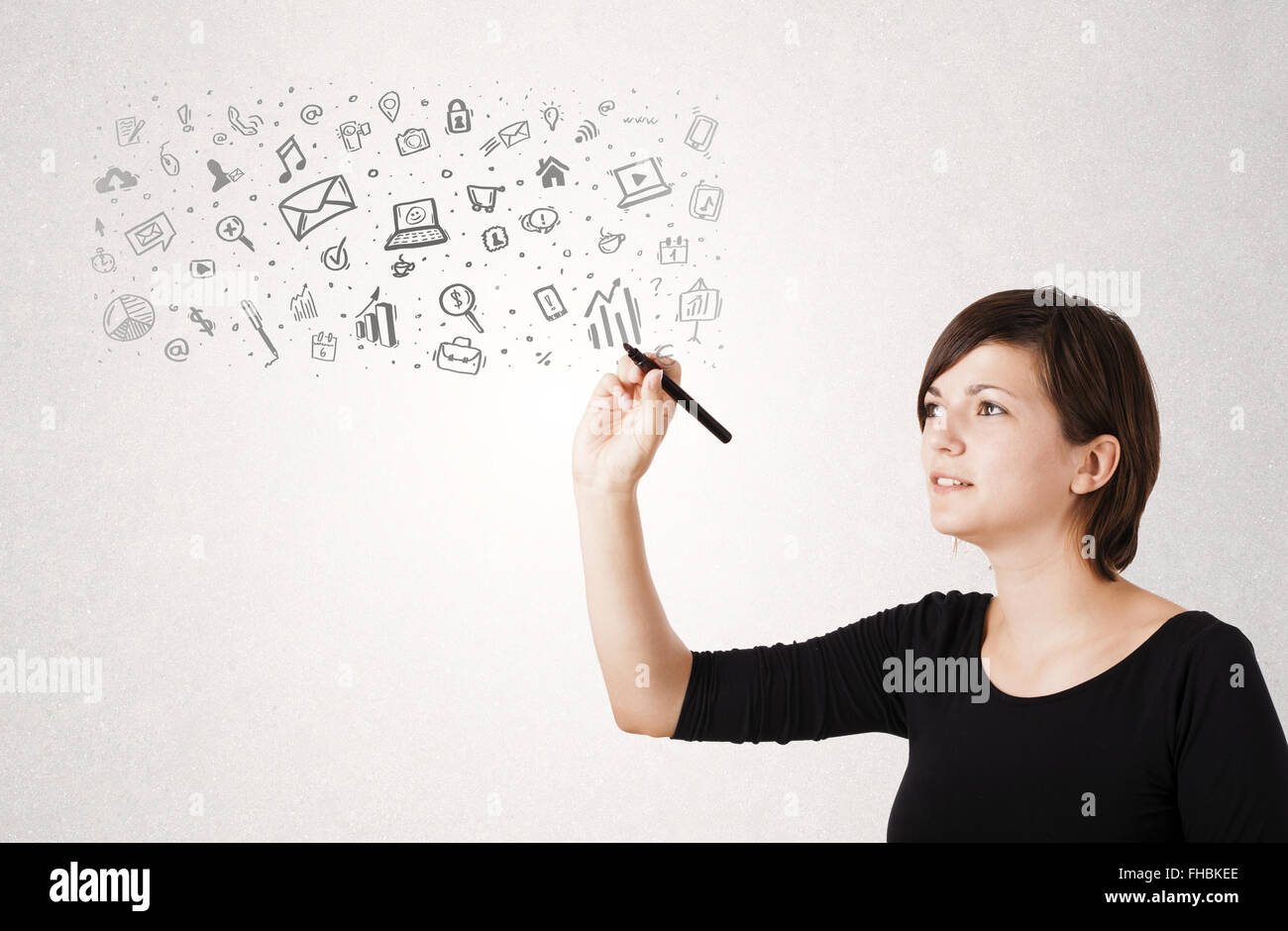 Young woman drawing and sketching icons and symbols Stock Photo - Alamy