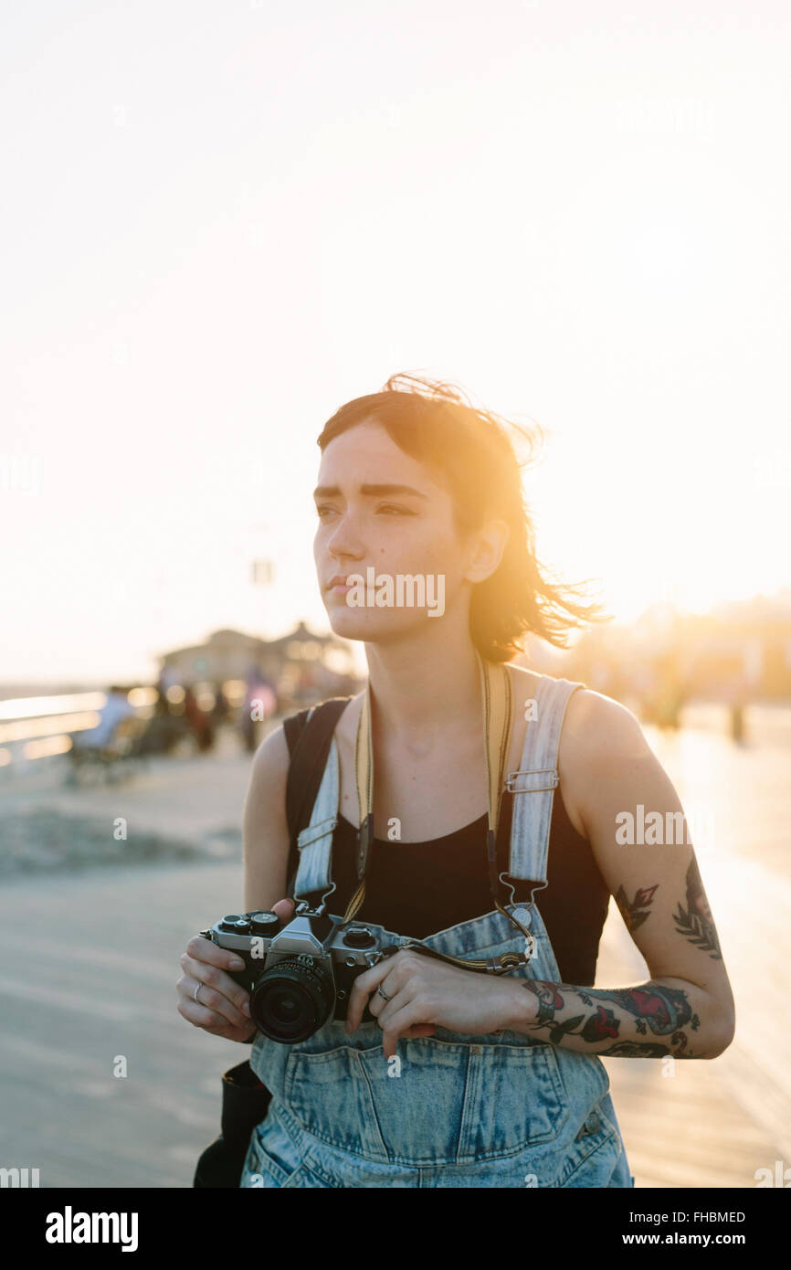 USA, New York, Coney Island, young woman taking photos at sunset Stock ...