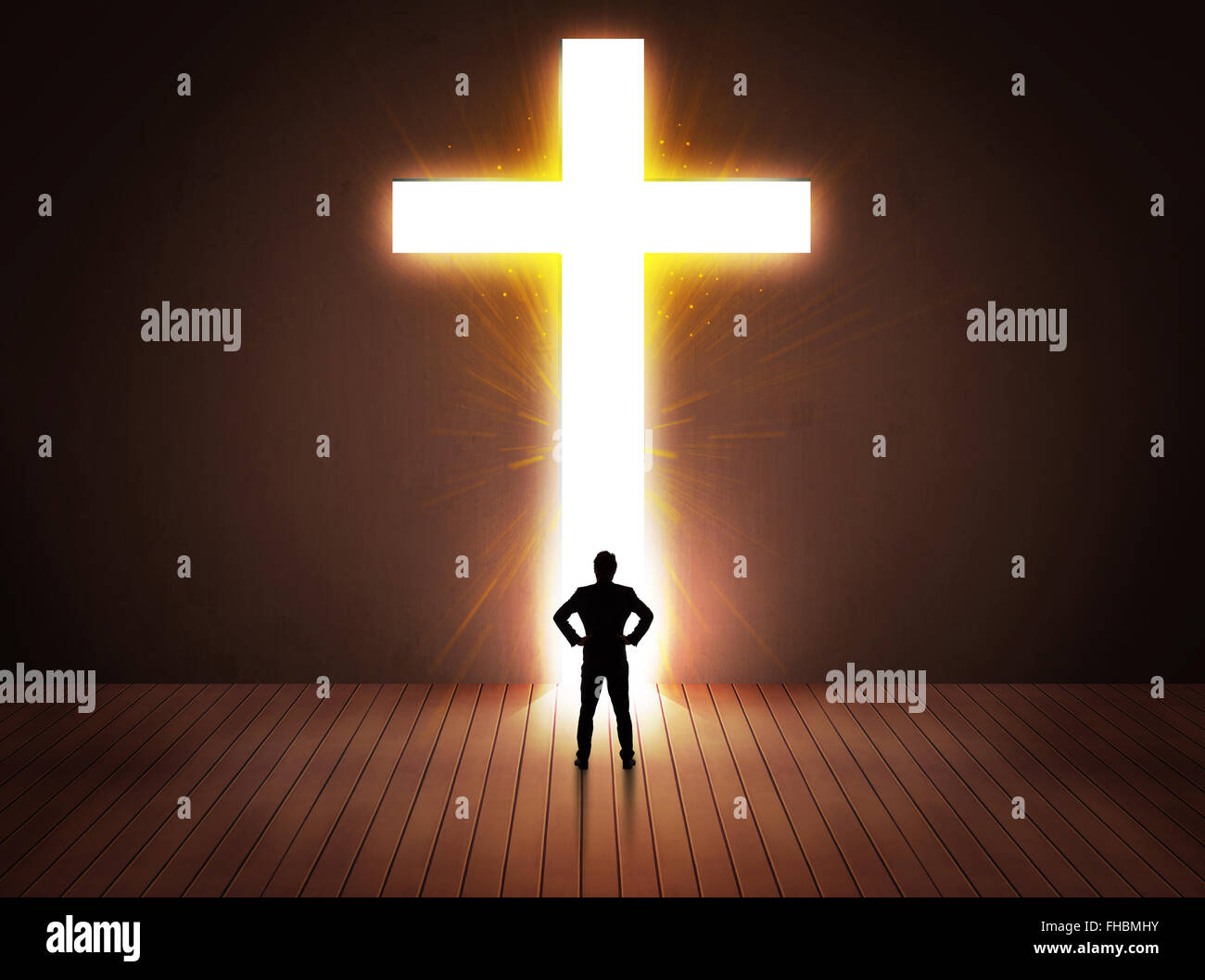 Man looking at bright cross sign Stock Photo