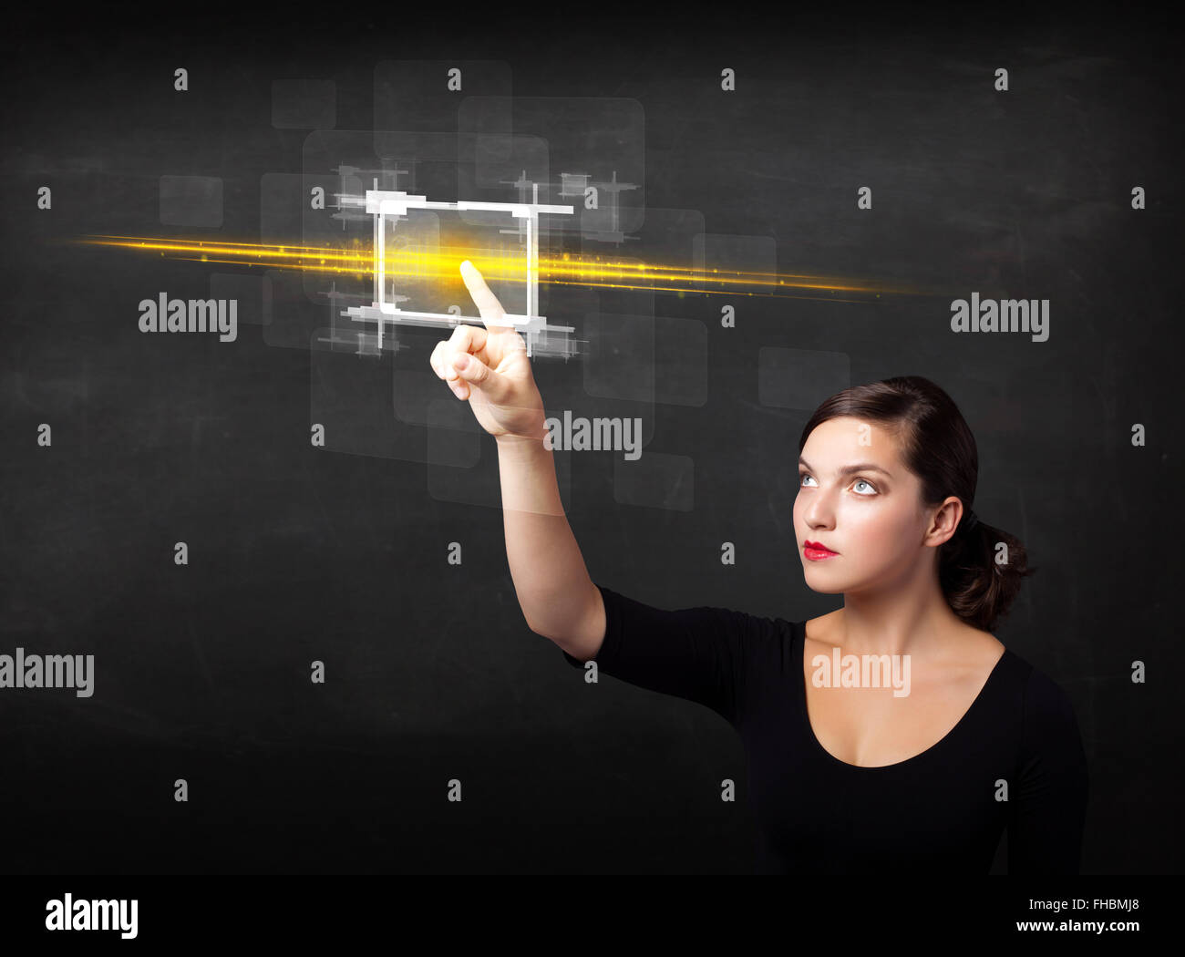 Young tech lady touching button with orange light beams concept Stock ...