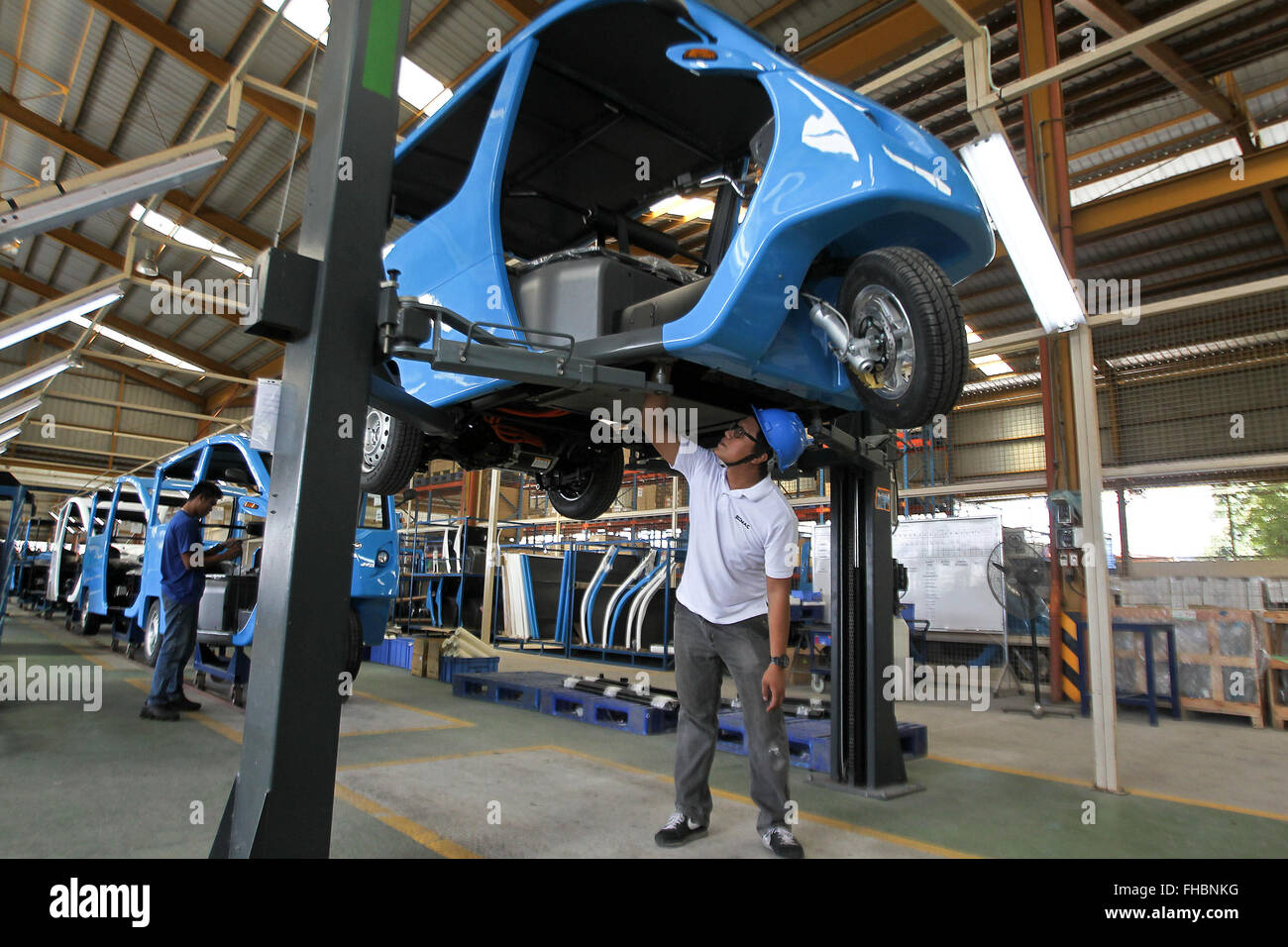 Laguna Province, Philippines. 24th Feb, 2016. A worker assembles an electric motor-powered tricycle or e-Trike at a production line in Laguna Province, the Philippines, Feb. 24, 2016. The 3,000 units of e-Trikes will be deployed within the year through a joint project between the Philippine Department of Energy and the Asian Development Bank. The Philippine government is pursuing a project to distribute 100,000 e-Trikes in an effort to reduce the environmental impact of using gasoline-fueled tricycles. Credit:  Rouelle Umali/Xinhua/Alamy Live News Stock Photo