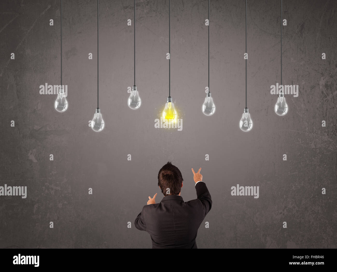 Businness guy in front of idea light bulbs concept Stock Photo - Alamy