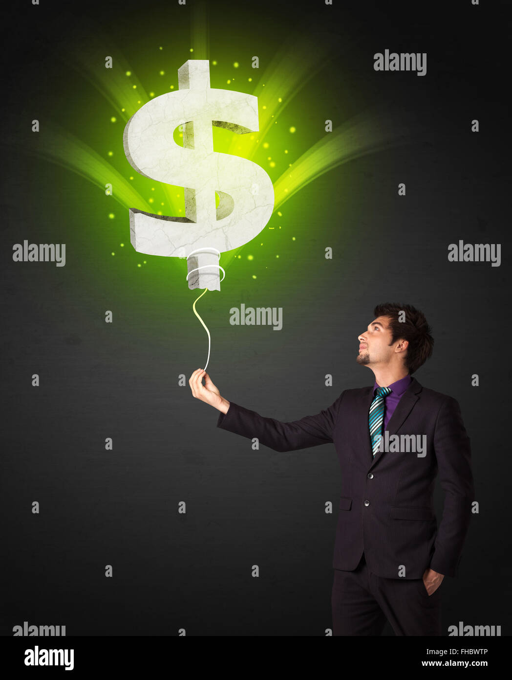 Businessman with a dollar sign balloon Stock Photo - Alamy
