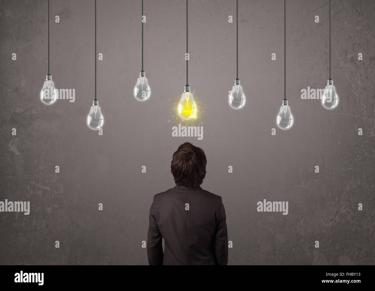 Businness guy in front of idea light bulbs concept Stock Photo - Alamy