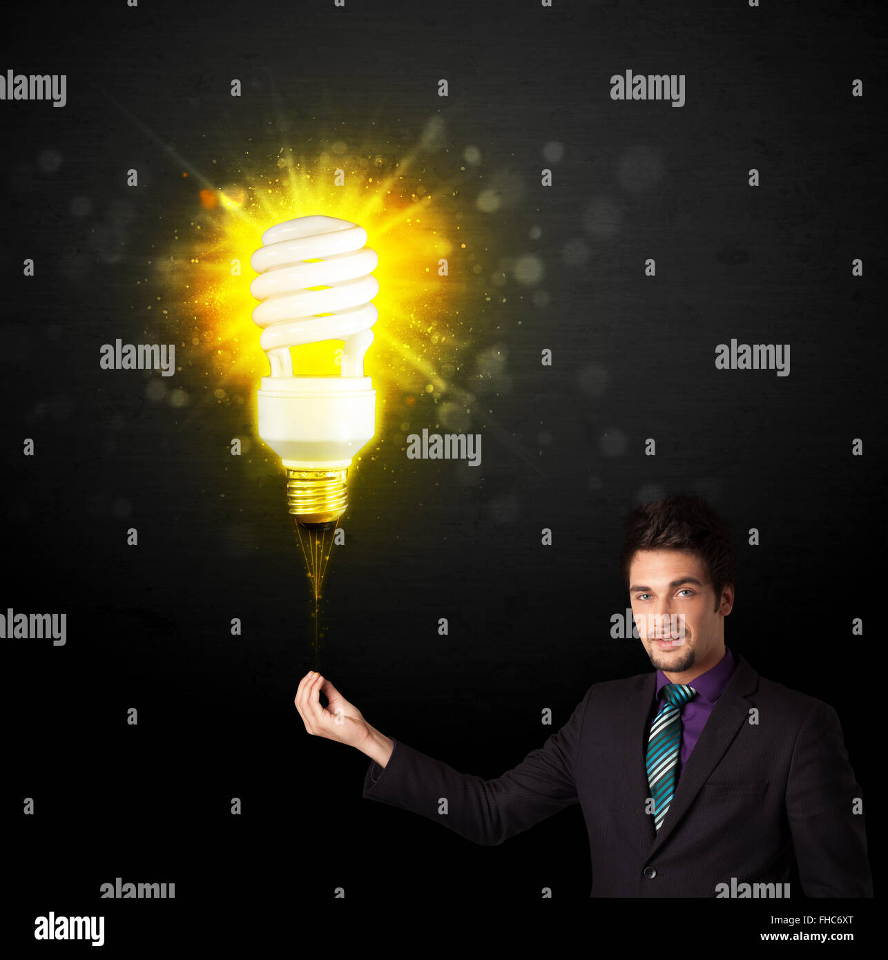 Businessman with an eco-friendly bulb Stock Photo