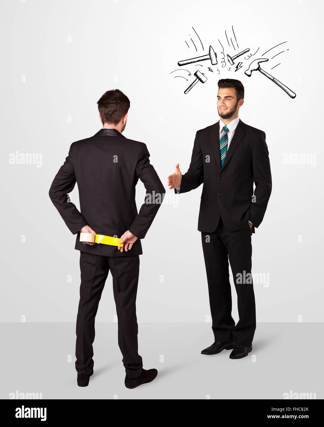 Businessman hiding a weapon Stock Photo - Alamy