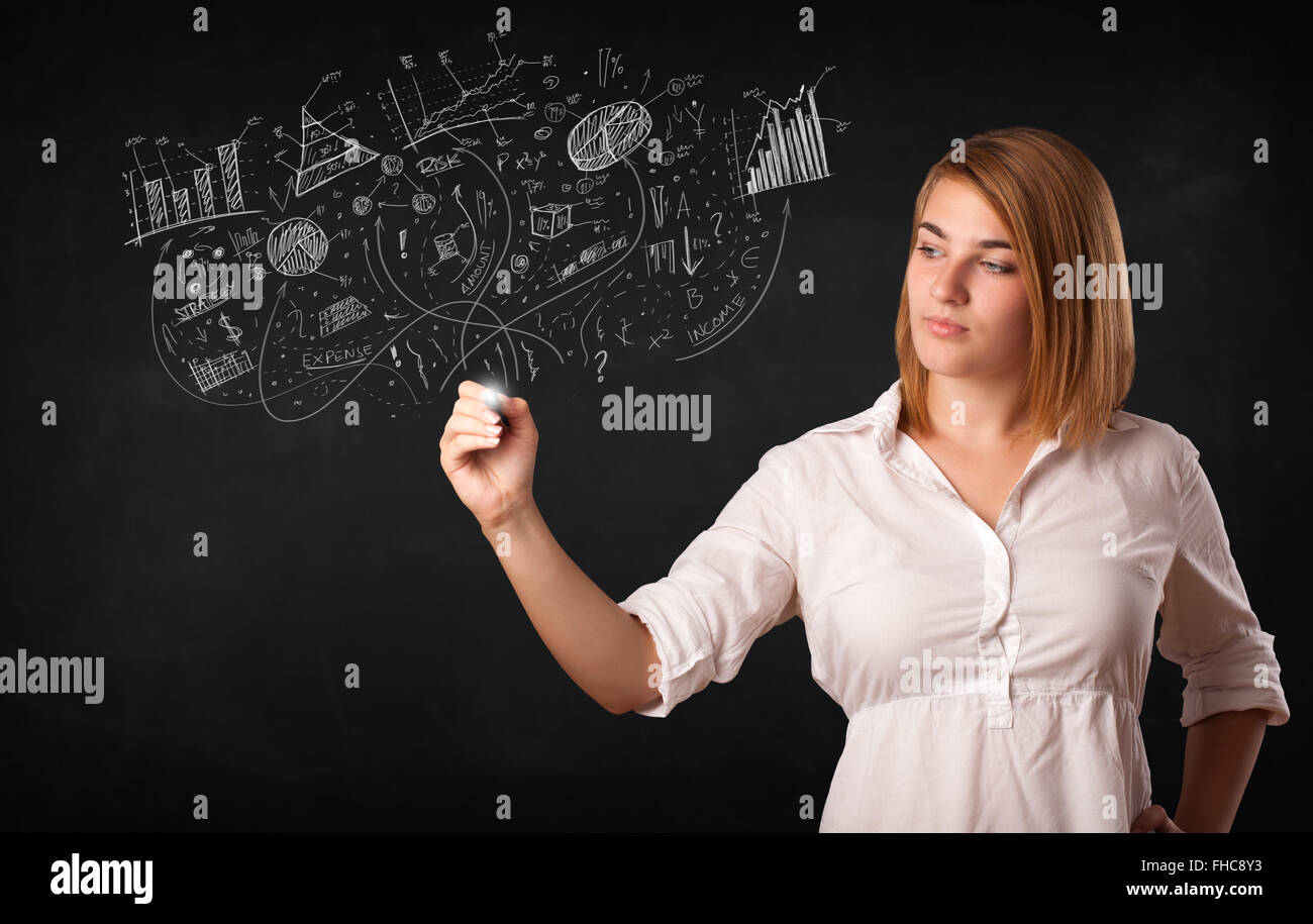 Pretty girl sketching graphs and diagrams on wall Stock Photo - Alamy