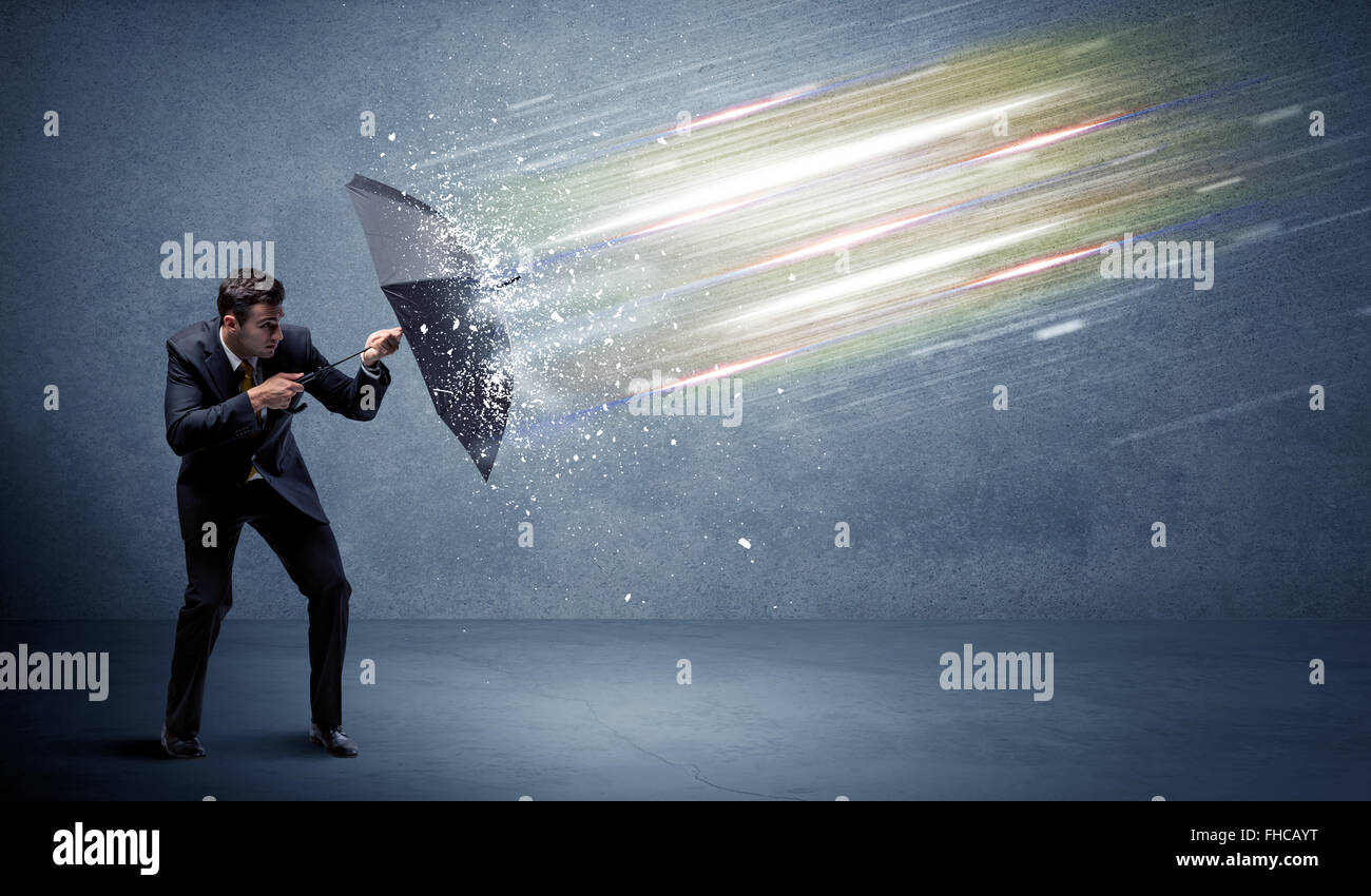Man Defrending Business man defending light beams with umbrella concept Stock Photo ...