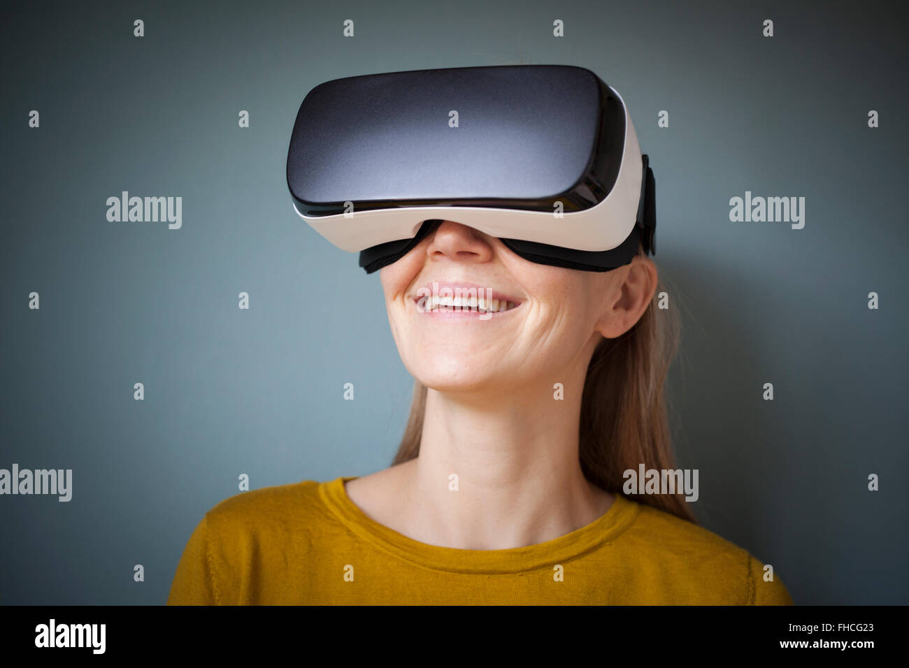Smiling woman wearing Virtual Reality Glasses Stock Photo