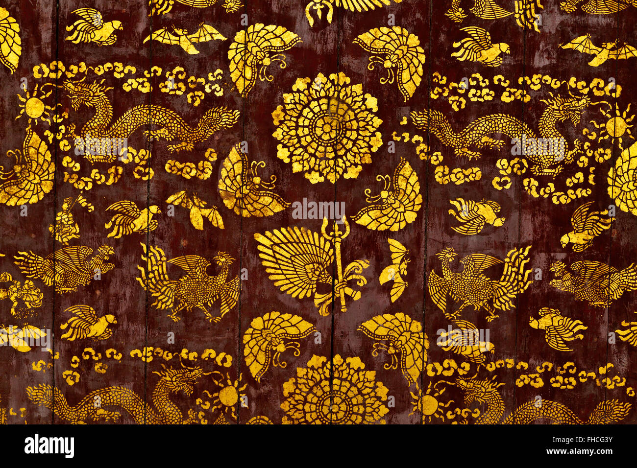 Stenciled DRAGON & PHONEIX ceiling designs on a BUDDHIST TEMPLE  - LUANG PRABANG, LAOS Stock Photo