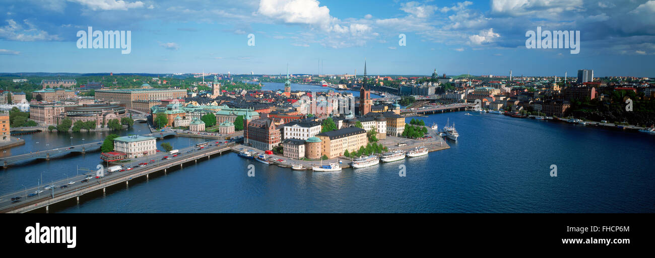 Panoramic overview from top of City Hall of Riddarholmen Island with ferryboats on Riddarfjarden waters in Stockholm Stock Photo