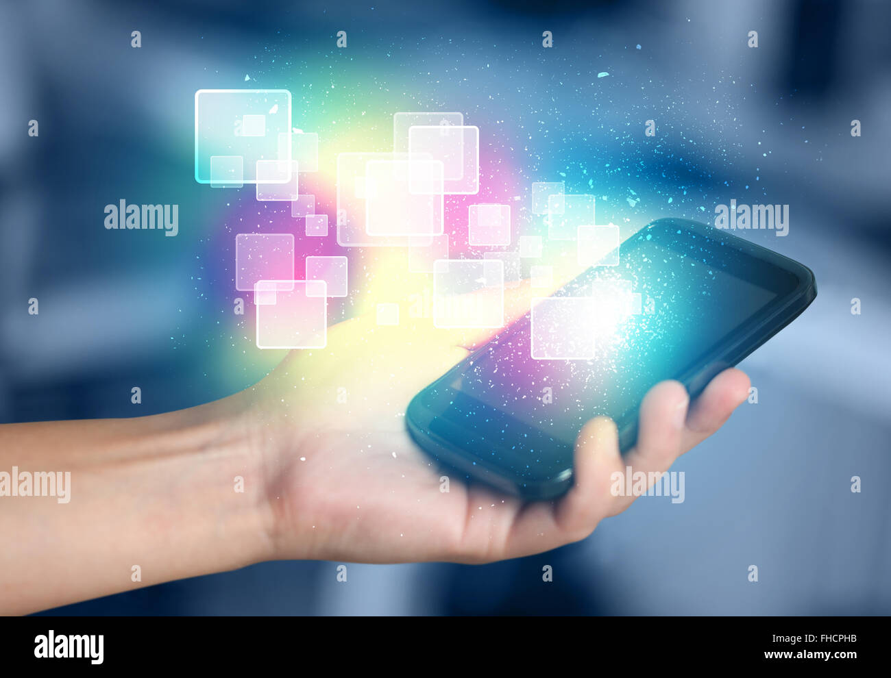 Hand holding smart phone with abstract glowing squares Stock Photo - Alamy