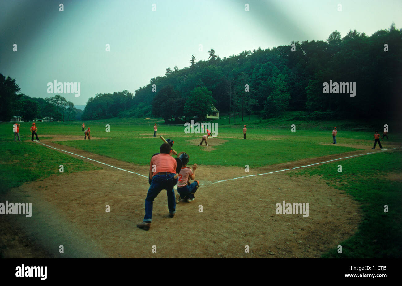Little league playing on old dirt country field.  Baseball diamond in Middle America Stock Photo