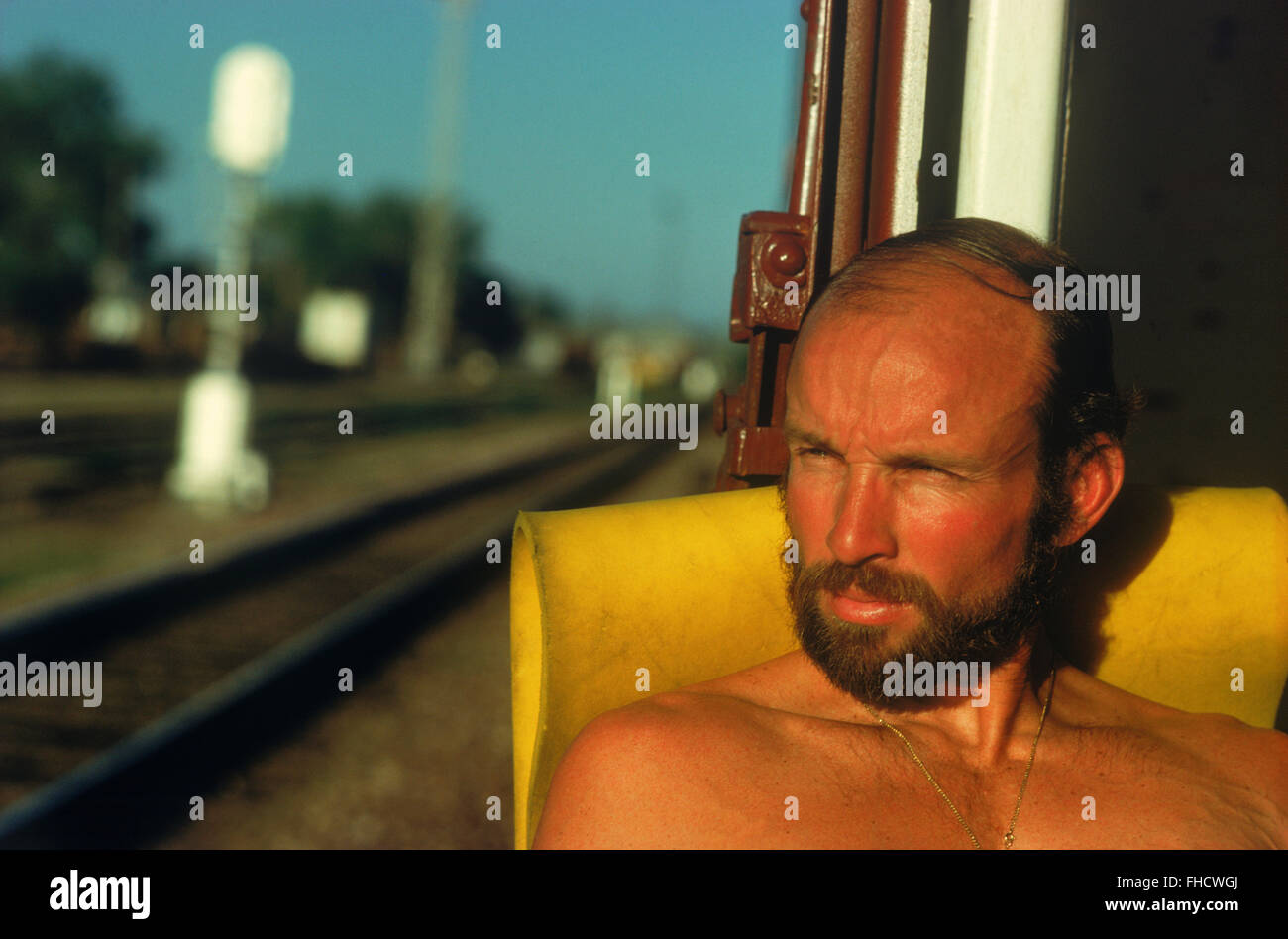 Train hobo and photographer Chad Ehlers riding the rail in box car across the plains of Montana Stock Photo