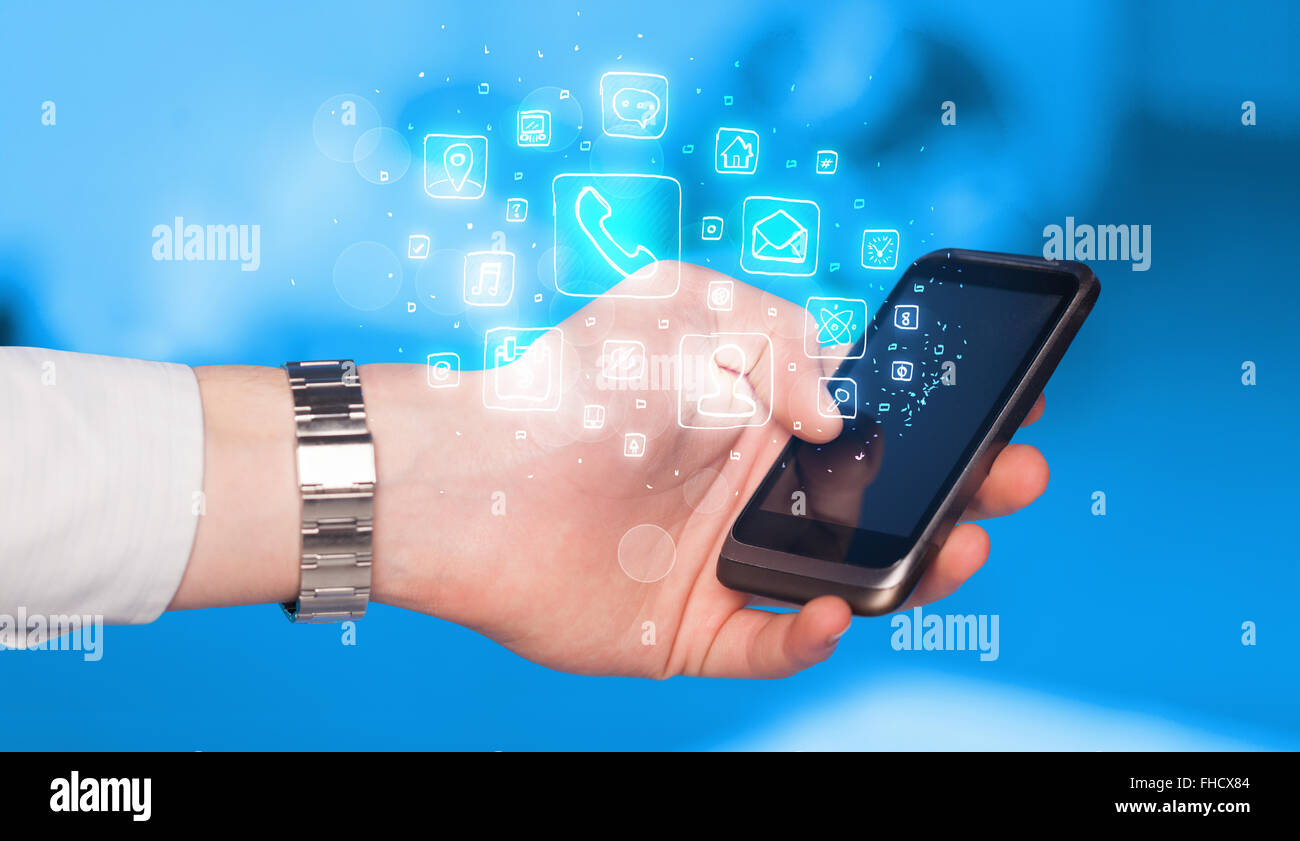 Hand holding smartphone with mobile app icons Stock Photo - Alamy