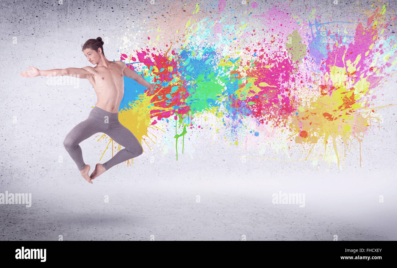 Modern street dancer jumping with colorful paint splashes Stock Photo ...
